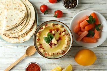 Concept of cooking hummus on white wooden background
