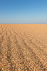 Fototapeta na wymiar Beautiful empty sand wave beach texture. Vertical.
