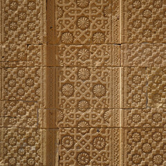 Beautiful traditional intricate geometric and floral carved stone detail inside the courtyard of a royal mausoleum in UNESCO listed Makli necropolis in Thatta, Sindh, Pakistan
