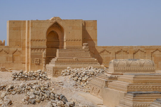 View of ancient carved stone cenotaphs inside the courtyard of a royal mausoleum in UNESCO listed Makli necropolis in Thatta, Sindh, Pakistan