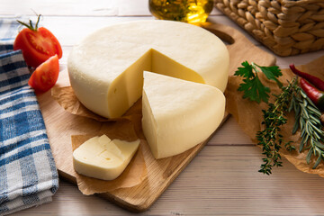 Cheese on a wooden background on the table with different ingredients