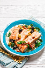 Salmon fish stew on a turquoise plate, top view