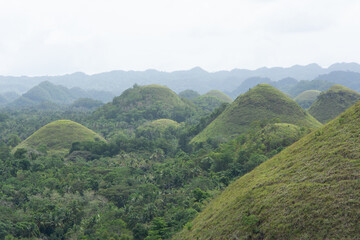 Chocolate Hills with a group of clouds in the sky