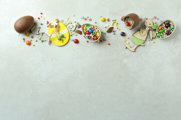 Obraz premium Easter concept with chocolate eggs on white textured background