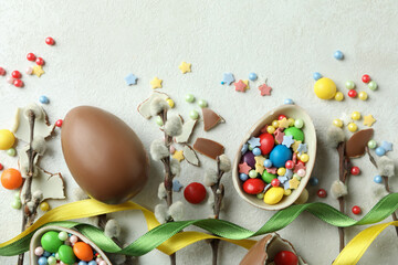 Fototapeta na wymiar Easter concept with chocolate eggs on white textured background