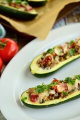 Zucchini boat filled with ground beef, mushroom, tomato sauce and parmesan cheese. Garnish with chopped parsley