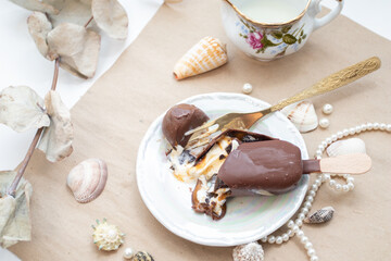 Cracking Ice cream with a fork. Chocolate ice cream with caramel is cracking.