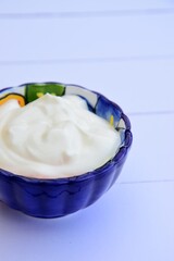 Greek yogurt in a bowl. White background
