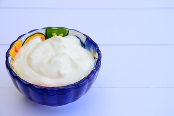 Greek yogurt in a bowl. White background
