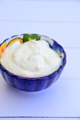 Greek yogurt in a bowl. White background
