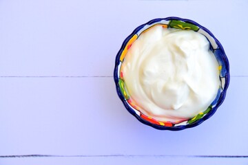 Greek yogurt in a bowl. White background
