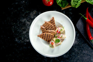 Classic dish of Israeli cuisine - herring forshmak with croutons served in a white plate on a marble background. Seafood.