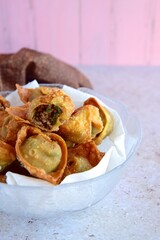 Deep fried beef wontons in a wok 
