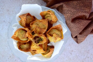 Deep fried beef wontons in a wok. Flat lay