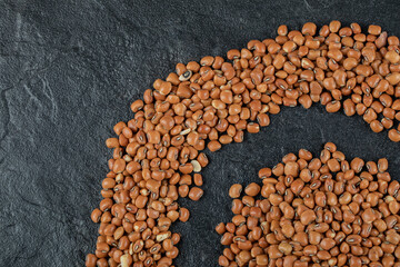 Brown kidney beans isolated on a dark background