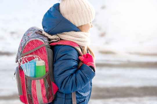 Pink backpack with hand sanitizer (hand rub) and medical face shield. The briefcase is not on the child's back. Back to school. Prevention of viruses and diseases in children. - Powered by Adobe