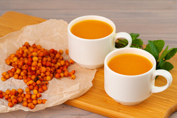 Sea buckthorn tea served on wooden table