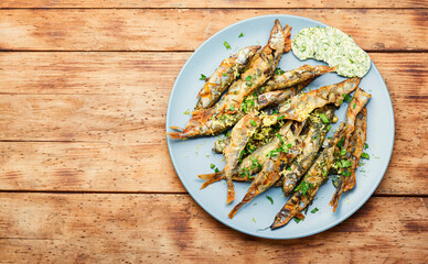 Fried capelin fish on plate