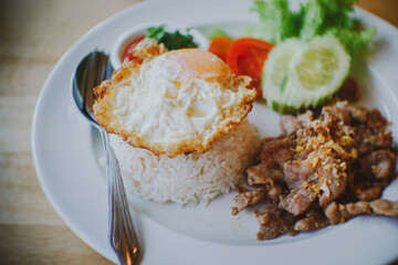 Thai food Fried Pork with Garlic , Pepper, Oyster Sauce And Fried Egg on Rice
