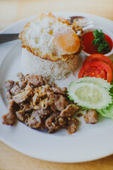 Thai food Fried Pork with Garlic , Pepper, Oyster Sauce And Fried Egg on Rice