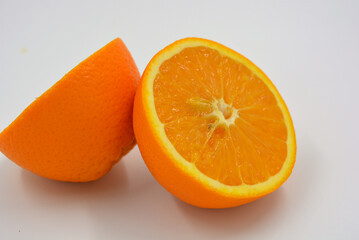 Useful and delicious fruits for human health. Orange oranges cut into two halves. Juicy fresh fades of orange with bones. 