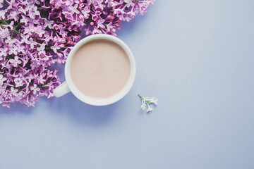 blue spring flowers lilac, cup of coffee with milk, place for text, spring texture