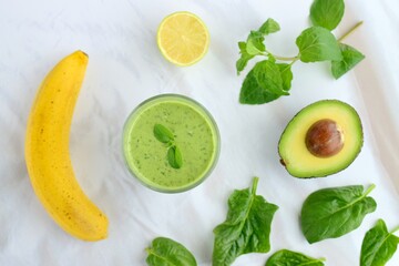 Green smoothie made from spinach , banana, avocado, soy milk and lime juice