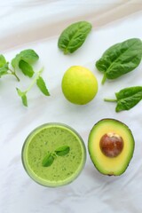 Green smoothie made from spinach , banana, avocado, soy milk and lime juice