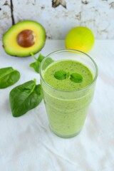 Green smoothie made from spinach , banana, avocado, soy milk and lime juice
