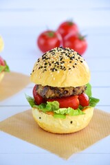 Vegetarian burger. Sesame bread bun with lentil patty, tomato, lettuce and yogurt
