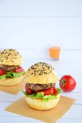 Vegetarian burger. Sesame bread bun with lentil patty, tomato, lettuce and yogurt