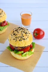Vegetarian burger. Sesame bread bun with lentil patty, tomato, lettuce and yogurt