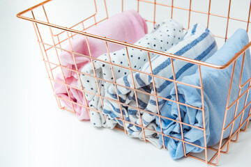 Vertical storage of clothing. Sorted clothes in baskets and shelves in a modern bedromm. Cleaning concept