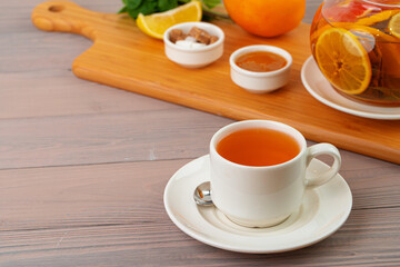 Obraz na płótnie Canvas Cup of tea served with lemon and mint