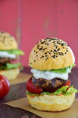 Vegetarian burger. Sesame bread bun with lentil patty, tomato, lettuce and yogurt