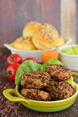 Beluga lentil rice patties with vegetarian burger on the background. Selective focus, blurred background
