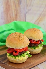 homemade beef burger with red bell peppers, lettuce and curry mayonnaise sauce
