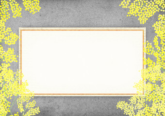 黄色いミモザの花とメッセージカードとコンクリート背景