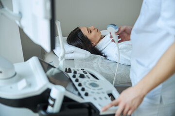 Experienced male doctor performing a diagnostic sonography procedure