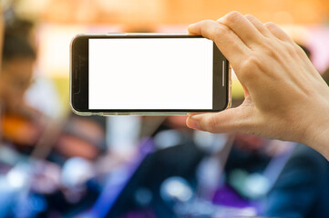 Close up of horizontal black smartphone with blank screen in woman hands. Mobile phone with blank copy space screen for your text.