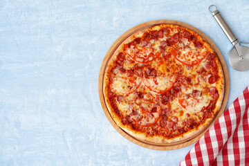 Delicious pizza with sausages on gray background