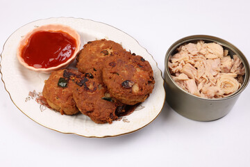 Tuna fish meat patty burger kebab with sauce on pate tuna flake chunk in tin can over white background