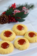 Thumbprint cookies on white background with Christmas decoration
