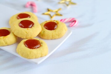 Thumbprint cookies on white background with Christmas decoration
