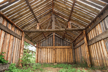 Fototapeta na wymiar Photo inside a empty barn with light streaming in through siding.