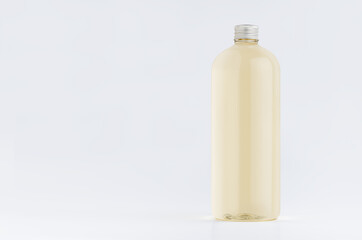 Transparent plastic tall bottle with pale fresh drink or cosmetic essential oil, silver cap mockup on white background. Template for portfolio, design, branding identity.