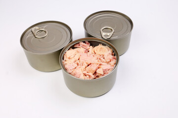 Tuna fish meat flaky chunk in tin can on white background