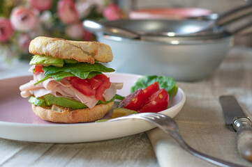 sandwich with chicken breast, avocado, tomato and spinach 