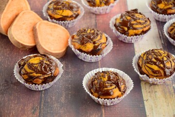 Sweet potato muffins with chocolate sauce topping