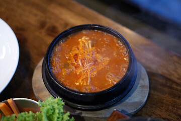 Kimchi Soup with tofu and pork belly served in clay pot, One of the most loved of all the stews in Korean cuisine.